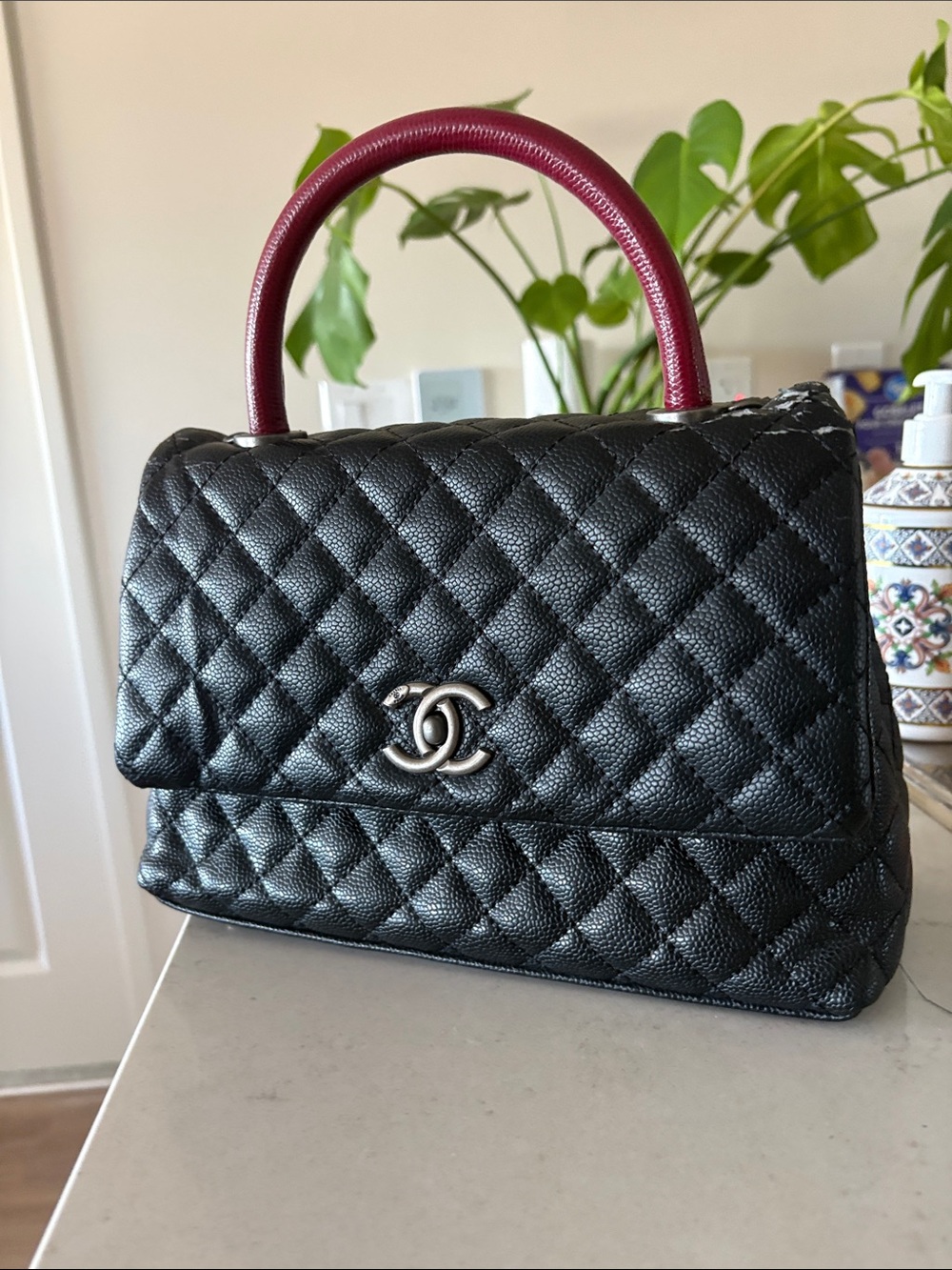 CHANEL Black Quilted Leather Top-Handle Bag with Burgundy Handle